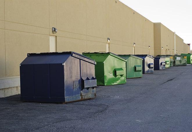 a group of construction workers taking a break near a dumpster in East Patchogue NY